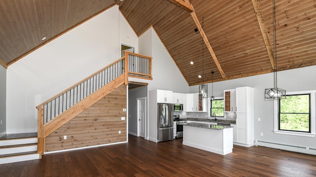 48 Harmony Row, Bethel, ME 04217 - kitchen featuring stainless steel appliances, high vaulted ceiling, a kitchen island, baseboard heating, and white cabinets
