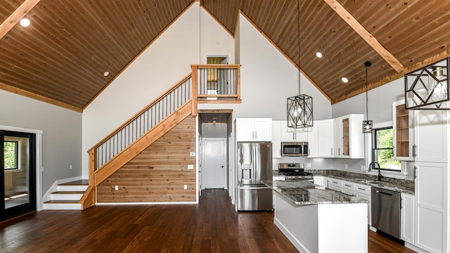 48 Harmony Row, Bethel, ME 04217 - kitchen featuring stainless steel appliances, high vaulted ceiling, a wooden ceiling with exposed beams, dark wood finished floors, and stone countertops