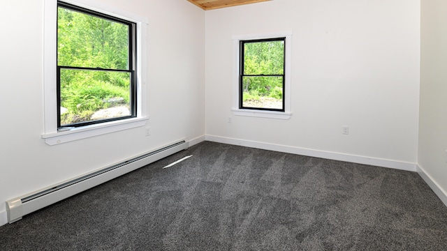 48 Harmony Row, Bethel, ME 04217 - empty room featuring a baseboard heating unit and dark colored carpet