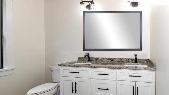 48 Harmony Row, Bethel, ME 04217 - bathroom featuring toilet and double vanity