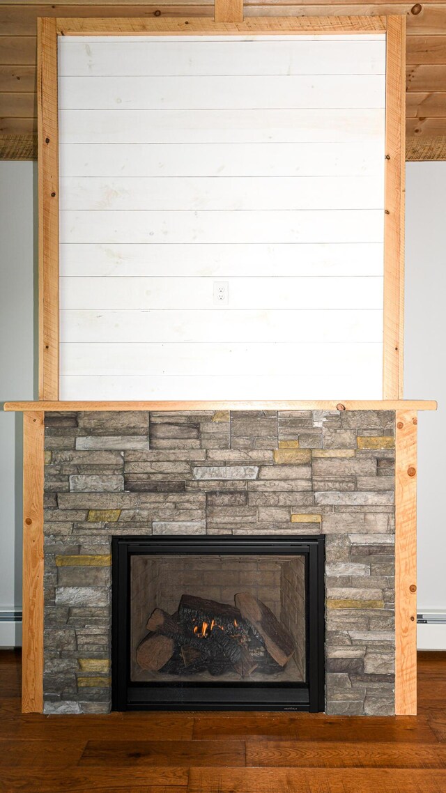 48 Harmony Row, Bethel, ME 04217 - detailed view of a fireplace, wood finished floors, and a baseboard heating unit