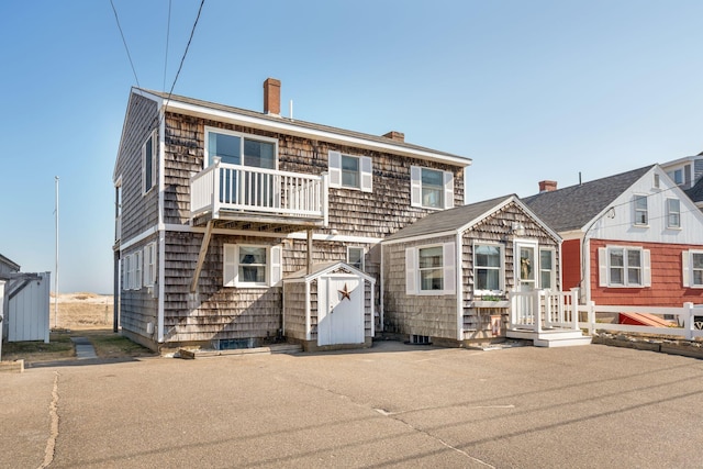 view of front facade with a balcony and a storage unit