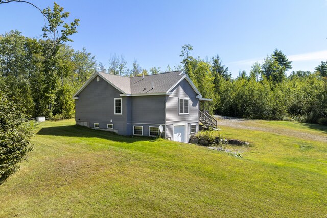 view of property exterior featuring a lawn