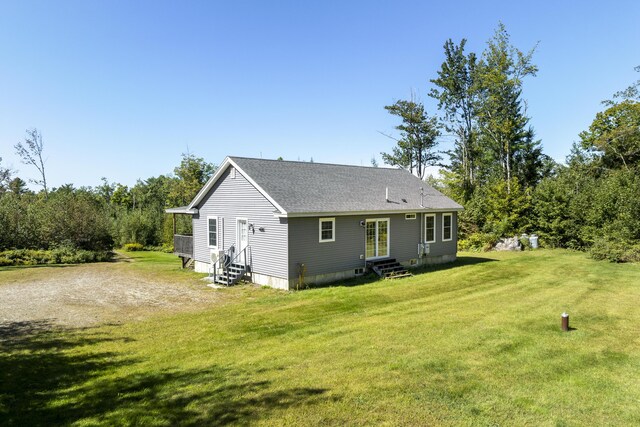 back of property featuring a yard