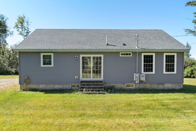 rear view of property featuring a yard