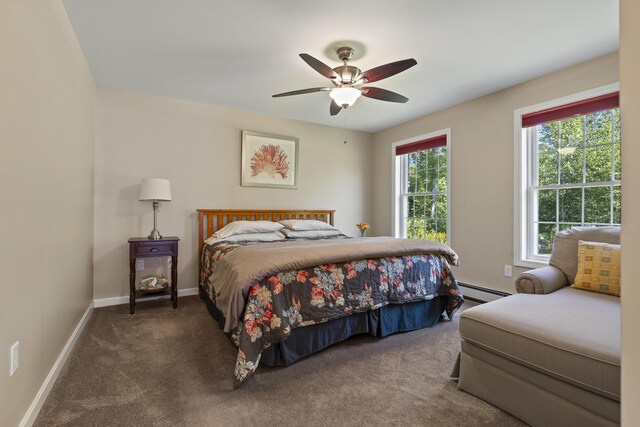 carpeted bedroom featuring baseboard heating and ceiling fan