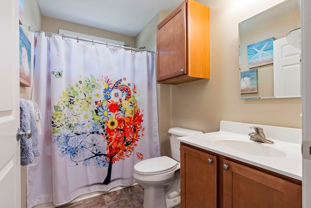 bathroom with toilet and vanity