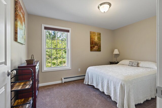 carpeted bedroom with a baseboard heating unit