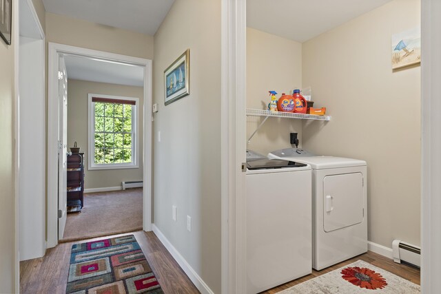 washroom with washer and clothes dryer, baseboard heating, and hardwood / wood-style floors