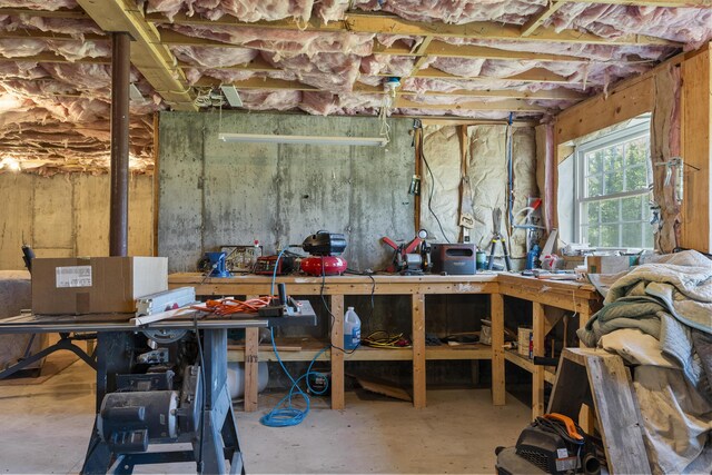 miscellaneous room featuring concrete floors and a workshop area