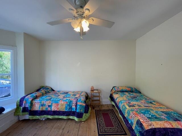 bedroom featuring ceiling fan and hardwood / wood-style flooring