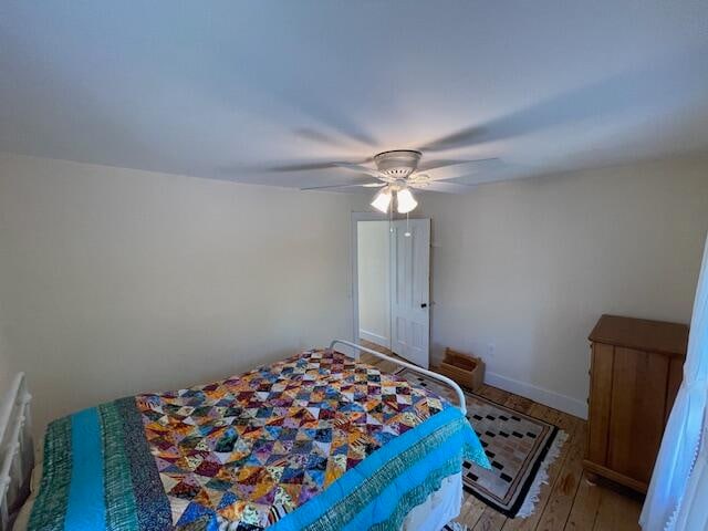 bedroom featuring ceiling fan and hardwood / wood-style floors