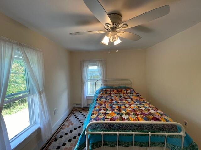 bedroom with ceiling fan and multiple windows