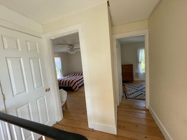 corridor with light hardwood / wood-style flooring