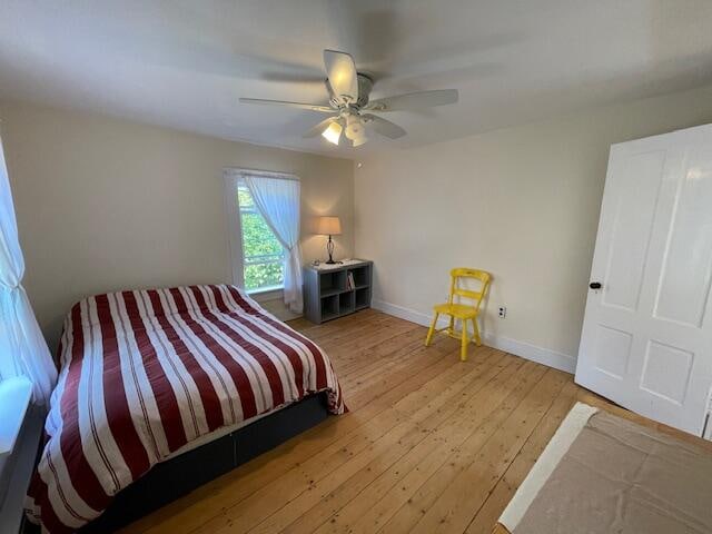 bedroom with ceiling fan and hardwood / wood-style flooring