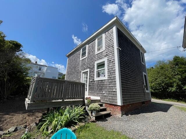 view of property exterior with a wooden deck