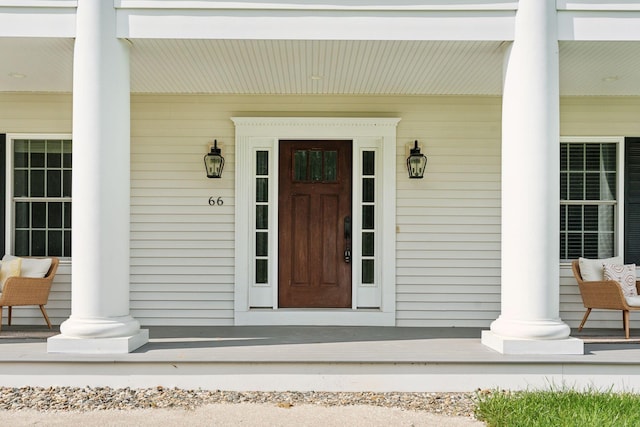 view of exterior entry with a porch