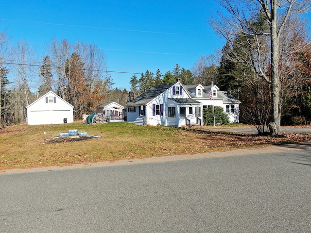 139 Lake Rd, Robbinston, ME 04671 - view of front of home featuring an outdoor structure, a front yard, and a garage