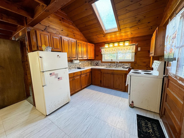 139 Lake Rd, Robbinston, ME 04671 - kitchen with white appliances, vaulted ceiling, a skylight, wooden ceiling, and wooden walls
