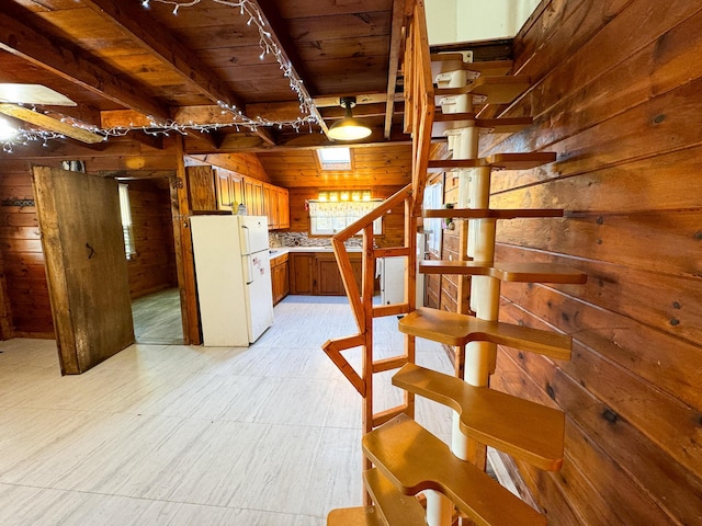 139 Lake Rd, Robbinston, ME 04671 - stairs featuring wooden ceiling, rail lighting, wooden walls, and beamed ceiling