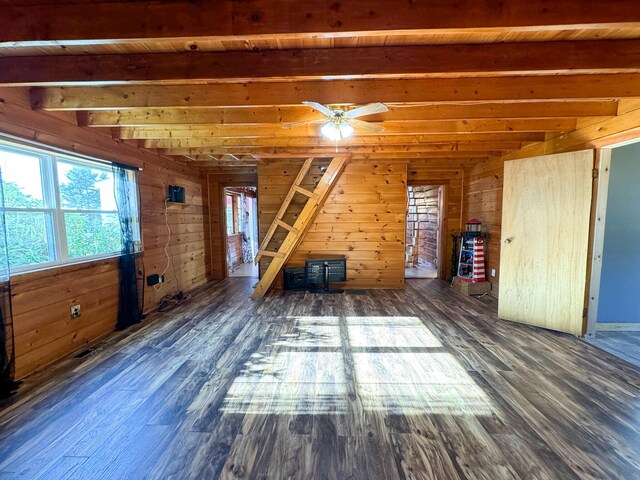 139 Lake Rd, Robbinston, ME 04671 - unfurnished living room featuring beamed ceiling, wood finished floors, wooden walls, and a ceiling fan