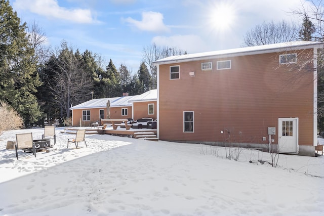 view of snow covered rear of property