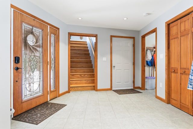 foyer entrance with light tile patterned floors