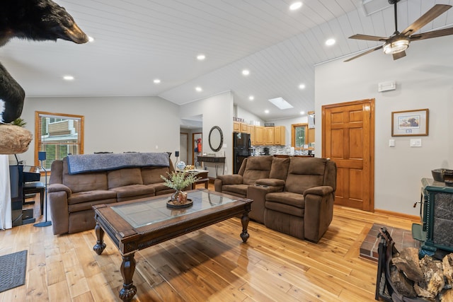 living room featuring wood ceiling, lofted ceiling with skylight, and light wood-type flooring