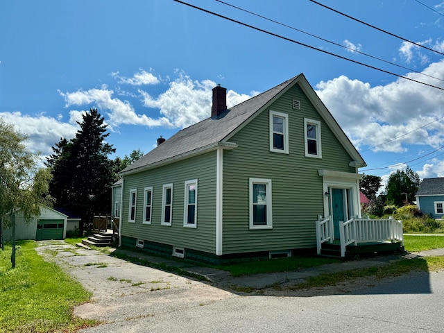 view of property exterior featuring an outdoor structure, a garage, and a lawn