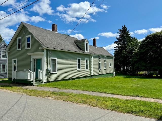 view of side of home featuring a yard