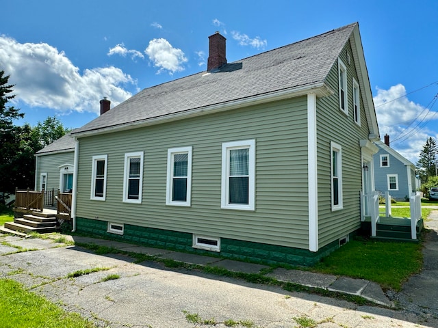 view of side of home featuring a yard