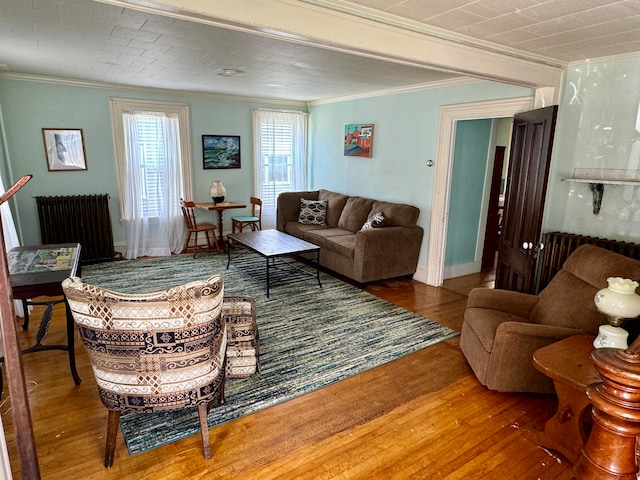 living room featuring ornamental molding, radiator, and hardwood / wood-style flooring