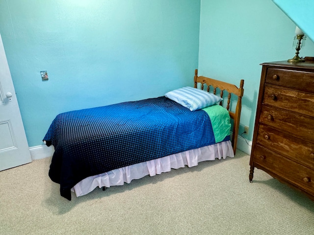 bedroom featuring light carpet