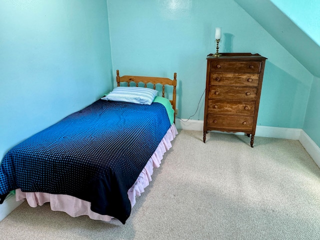 bedroom with lofted ceiling and carpet flooring