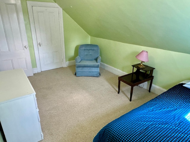 bedroom featuring lofted ceiling and carpet flooring