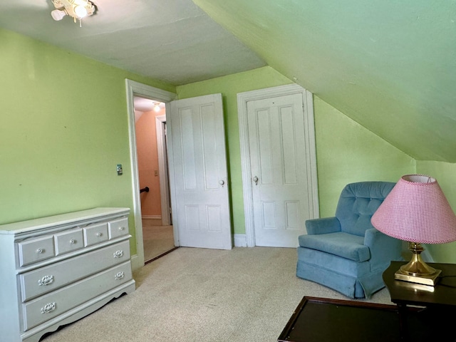 living area featuring lofted ceiling and light colored carpet