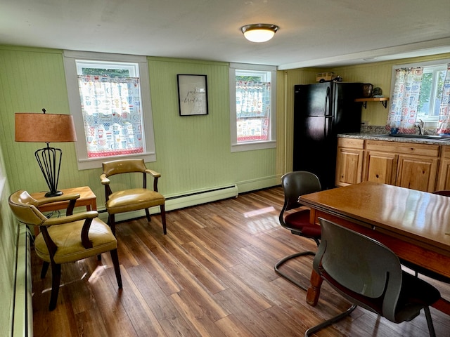 home office with a healthy amount of sunlight, sink, and wood-type flooring