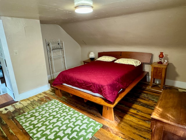 bedroom featuring lofted ceiling and wood-type flooring