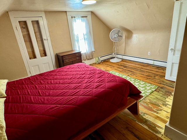 bedroom featuring vaulted ceiling, a baseboard radiator, and dark hardwood / wood-style floors