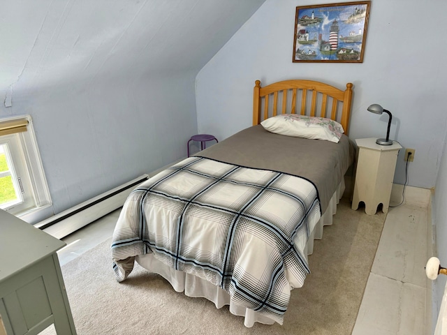 carpeted bedroom with a baseboard heating unit and vaulted ceiling