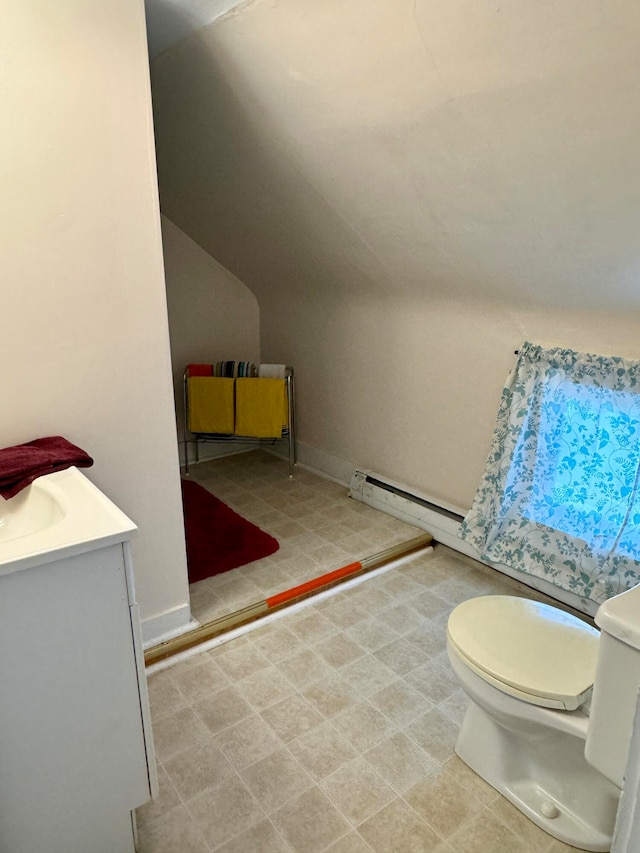 bathroom featuring a baseboard heating unit, vanity, toilet, and lofted ceiling