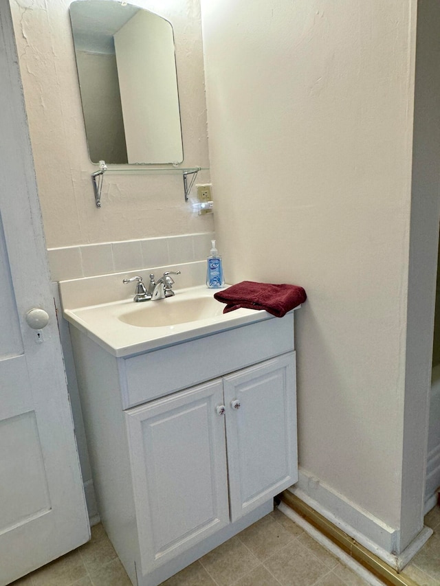 bathroom featuring vanity, decorative backsplash, and tile patterned floors