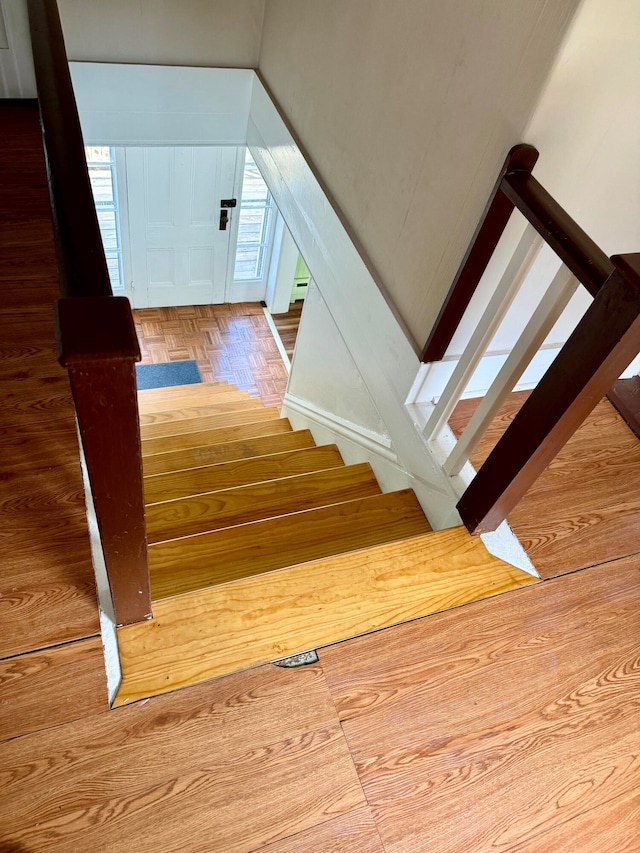 stairs with a baseboard radiator and hardwood / wood-style flooring