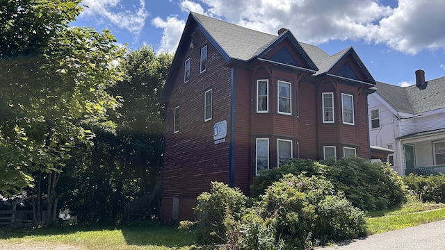 view of side of home with a lawn