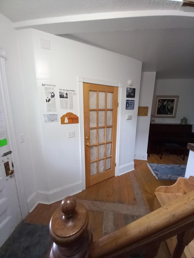 interior space featuring baseboards and wood finished floors