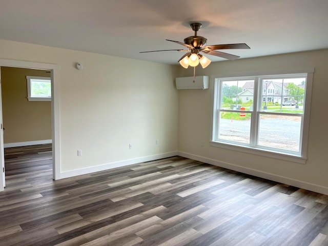 unfurnished room with a wall mounted AC, ceiling fan, and wood-type flooring