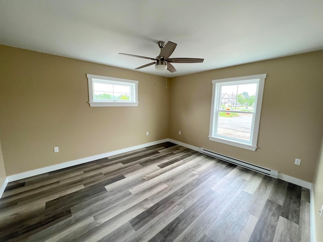 spare room with a baseboard heating unit, wood-type flooring, plenty of natural light, and ceiling fan