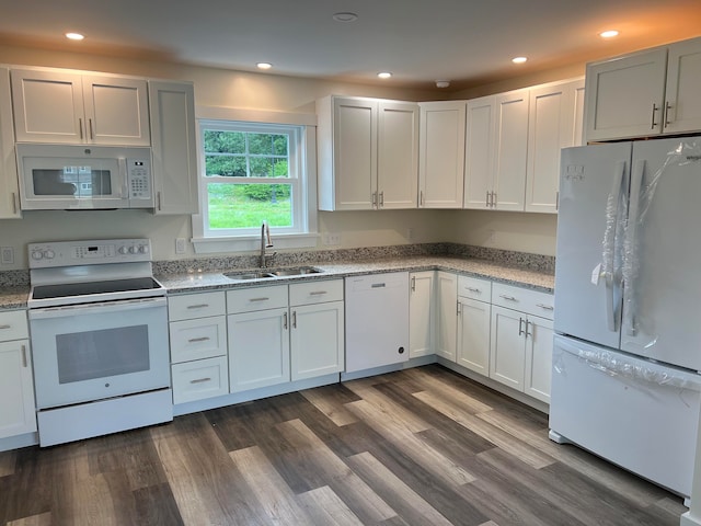 kitchen featuring white cabinetry, white appliances, light stone counters, sink, and dark hardwood / wood-style floors