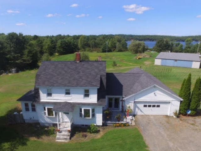 view of front facade with a front lawn and a garage