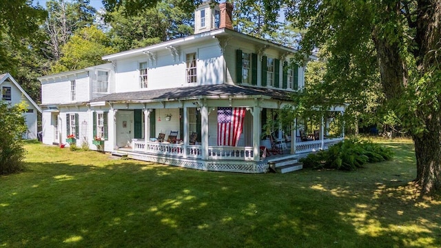 292300 Main Rd, Islesboro, ME 04848 - view of front of house with a front lawn, a chimney, and covered porch